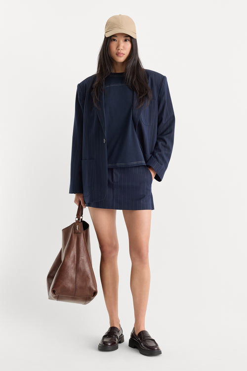 THE TROUSER MINI SKIRT | NAVY PINSTRIPE-1 | GOOD AMERICAN | MODEL